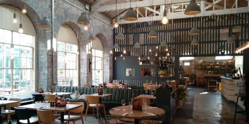 Commercial electrical fault finding and emergency lighting repair work inside a large Plymouth restaurant with complex industrial pendant light fixtures.